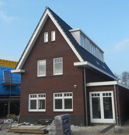 Donkere bakstenen woning met puntgevel